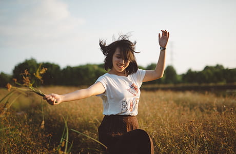 woman holding flower at field thumbnail