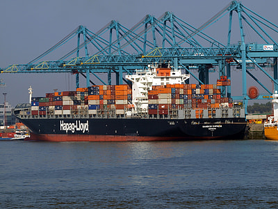 black and orange cargo ship docked on blue pier thumbnail