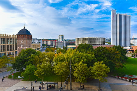 trees near concrete buildings landscape photographu thumbnail