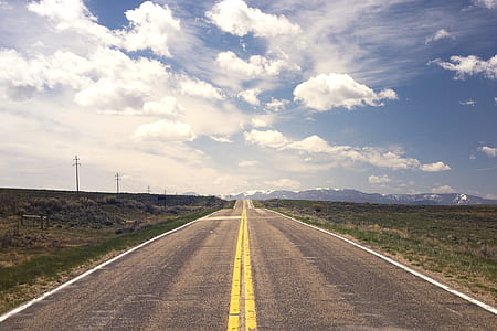 concrete road towards mountains thumbnail