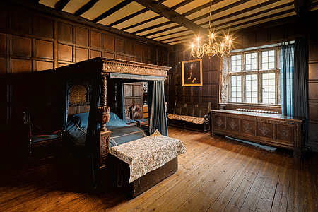 brown wooden bedroom interior with blue bedspread thumbnail