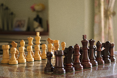 tilt shift lens photography of brown chess set thumbnail