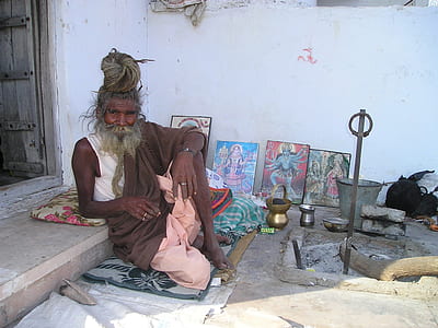 man sitting on concrete surface beside wall thumbnail