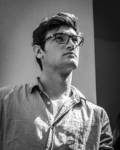 Grayscale Photo of Man Looking Up Wearing Button-up Shirt thumbnail