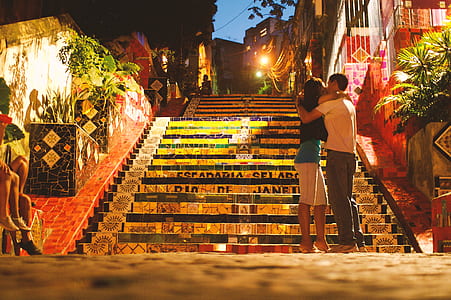 man and woman kissing at the bottom of stairs thumbnail