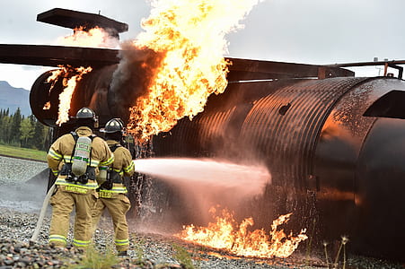 firefighters pointing the water hose to the plane on flame thumbnail