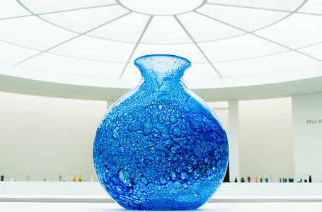 blue glass vase under glass ceiling thumbnail