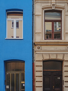 two blue and beige concrete buildings thumbnail