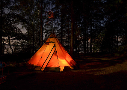 orange tend surrounded by trees during nighttime thumbnail