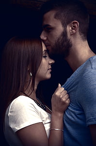 man in grey shirt kissing woman in forehead thumbnail
