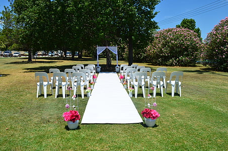 white plastic armless chairs near green leaf trees under clear blue sky photo taken during dayitme thumbnail