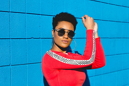 woman leaning on blue wall thumbnail