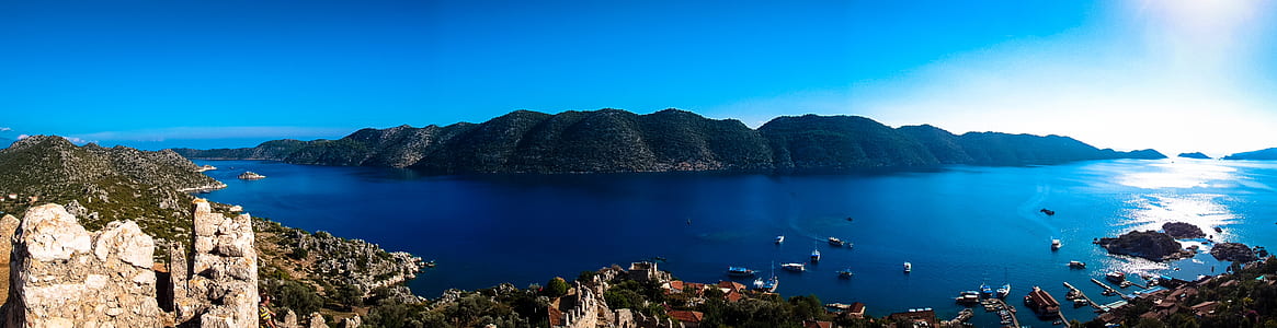 bodies of water near island full of buildings panoramic photography thumbnail