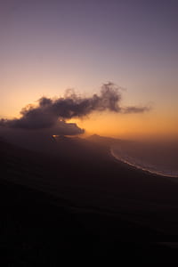 hills near seashore at dusk thumbnail