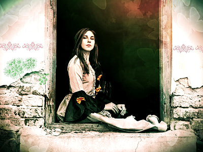 woman in long-sleeved flare dress standing beside window thumbnail