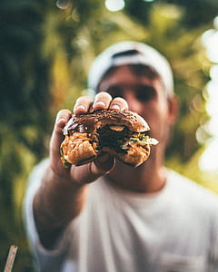 person holding burger thumbnail