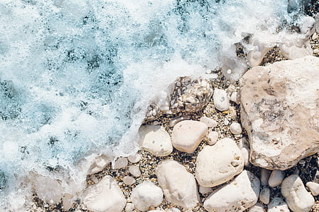 sea waves crashing on white stones at daytime thumbnail