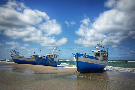photography of three blue boats during daytime thumbnail