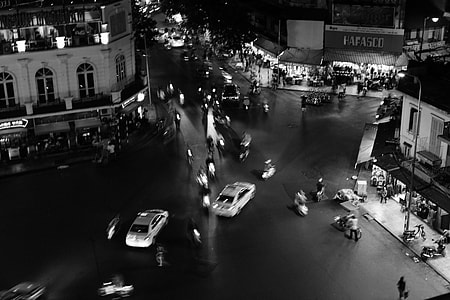 grayscale photo of crowd of people on road near building thumbnail