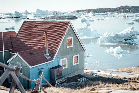 gray concrete house near body of water thumbnail