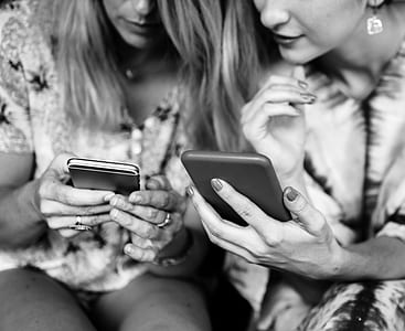 two woman using smartphones thumbnail