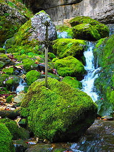 sword on moss-covered rock boulder thumbnail
