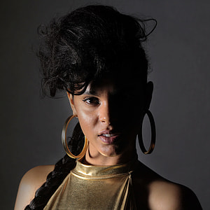 woman wearing gold hoop earrings thumbnail