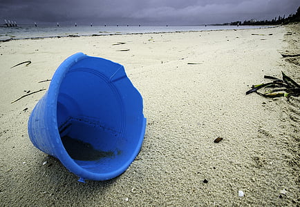 photo of blue plastic pail on beach thumbnail