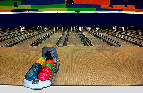 several bowling balls in rack thumbnail