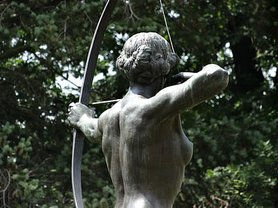 female archer statue near green leaf tree thumbnail