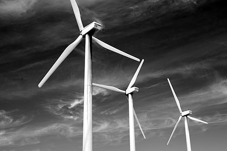 three wind turbines under grey cloudy sky thumbnail