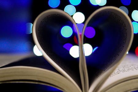 Photo of Bookpages Folded Into Heart Shape With Bokeh Light Background thumbnail