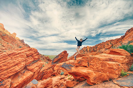 woman jumps on rock cliff thumbnail