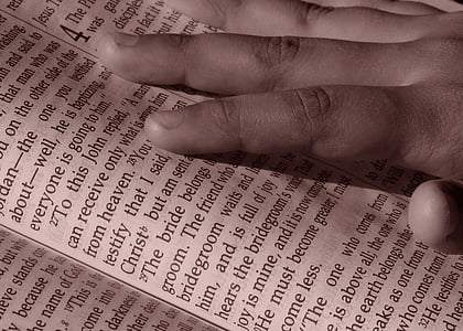 person's hand touching book thumbnail