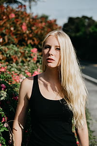 woman wearing black tank top near pink petaled flowers thumbnail