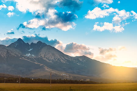 Epic view on mountains with blue sky with clouds at sunset thumbnail