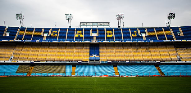 panoramic photography of blue, yellow and teal football stadium during daytime thumbnail