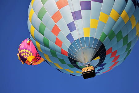 Blue and Multicolored Hot Air Balloon Under Blue Sky thumbnail