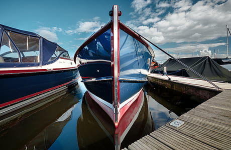blue boat beside dock thumbnail
