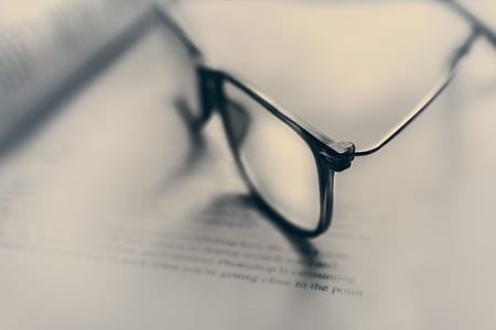 tilt shift photography of eyeglasses with silver-colored frames thumbnail