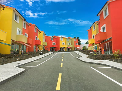 yellow and orange concrete houses during daytime thumbnail