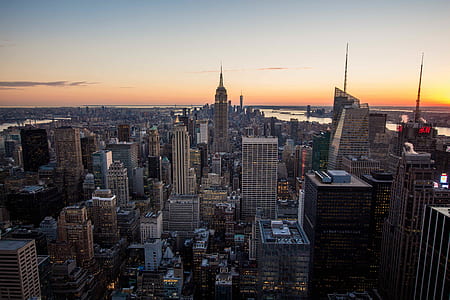 aerial view of Empire State Building surrounded by commercial high-rise buildings during orange sunset thumbnail
