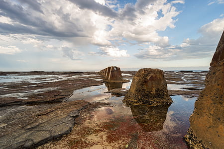 rock formation near body of water thumbnail