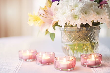 white petaled flowers and four pink tealight candles thumbnail