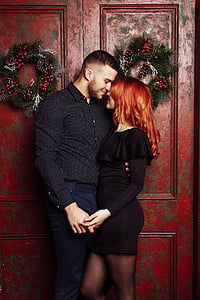 man and woman facing each other near door thumbnail