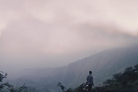person standing front of mountain thumbnail