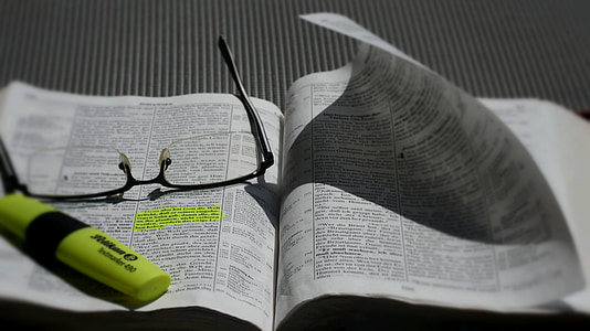eyeglasses and yellow highlighter on white book thumbnail