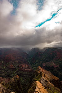 aerial photography of brown and green mountains under white cloud blue skies thumbnail