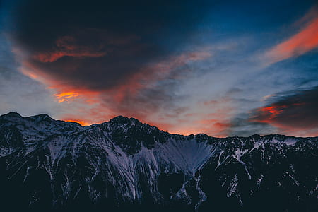 snow-covered mountain under cloudy sky thumbnail