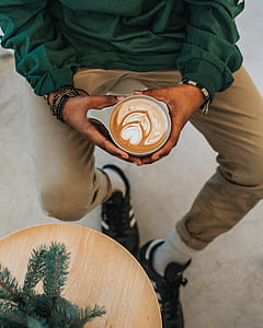 person holding cup filled with coffee thumbnail